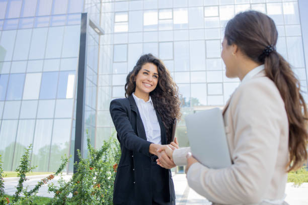 istock Two businesswomen are talking outside 1643050581