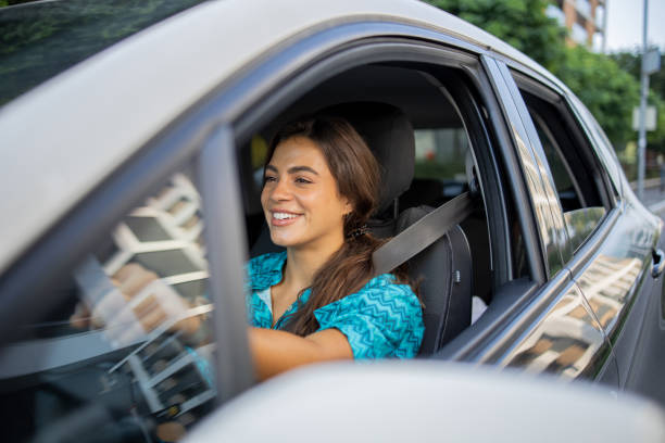 istock Woman is driving a car on her way to work 1643052824