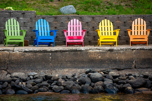 Colorful adirondack chairs on a Wisconsin lake,  horizontal