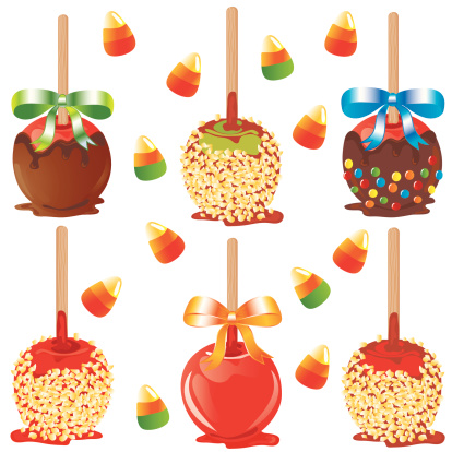 Selection of carmel and chocolate dipped apples with nuts and candy