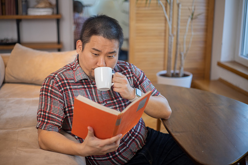 Portrait of a man reading a book