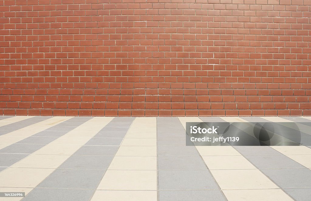 Red brick wall  and tiled floor Red brick wall and  tiled floor Backgrounds Stock Photo