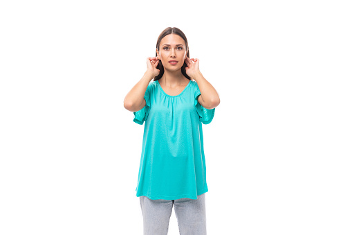 young brunette european lady with straight hair dressed in blue t-shirt isolated on white background in copy space.