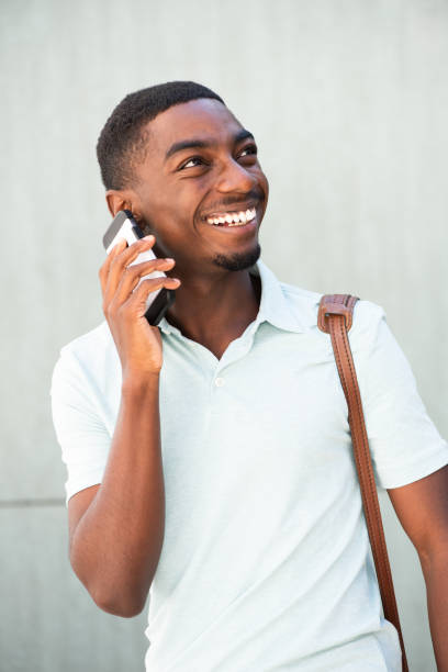 istock confident smiling young black man talking with mobile phone 1643276372