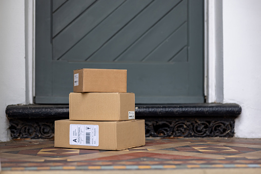 Close-up on a packages left on the porch of a house - online shopping concepts