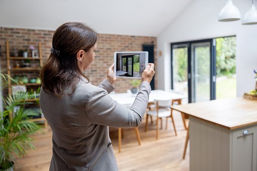 Real estate agent doing a virtual showing of a property using a digital tablet