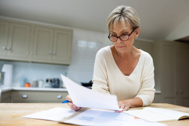 istock Senior woman at home checking her bank statements 1643300657