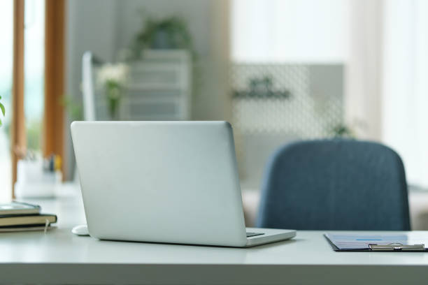 istock Bright modern workplace with laptop computer and office supplies. 1643302631