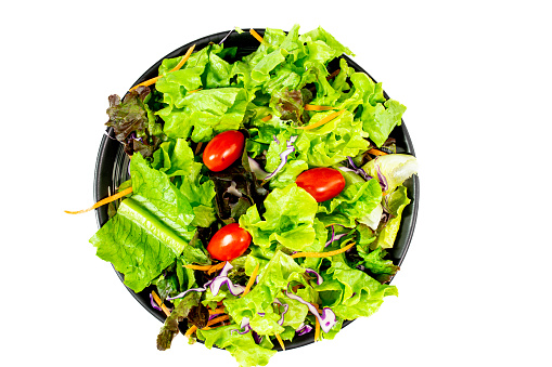 Vibrant and crisp garden-fresh salad beautifully presented in a sleek black bowl, set against a clean white backdrop. Clipping path included.