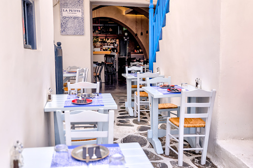 Mykonos, Greece - July 21, 2023: The patio of a small cafe in the streets of Mykonos Town in Greece