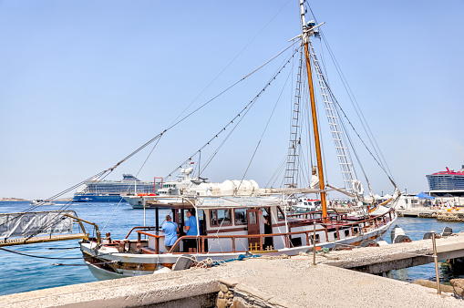 Mykonos, Greece - July 21, 2023: Vessels moored along the pier in Mykonos Town, Greece