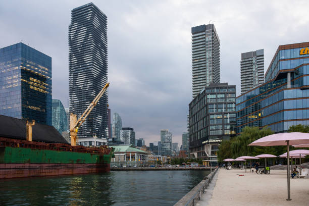 Toronto, Ontario, Canada - Aug 20, 2023: The Toronto waterfront area has undergone significant redevelopment, transitioning from an industrial zone to a mixed-use urban space. This has led to discussions about the future of the Redpath Sugar Refinery and its role in the evolving cityscape.