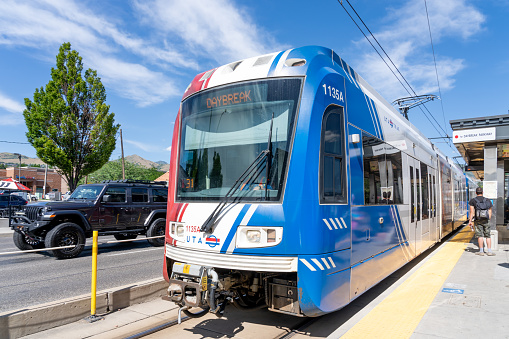 A UTA TRAX light rail train at a TRAX station in Salt Lake City, Utah, USA - June 24, 2023. TRAX is a light rail system in the Salt Lake Valley of Utah.