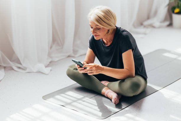 istock A Happy Blonde Senior Woman Watching Some Yoga Classes While Using An App On Her Mobile Phone 1643361759