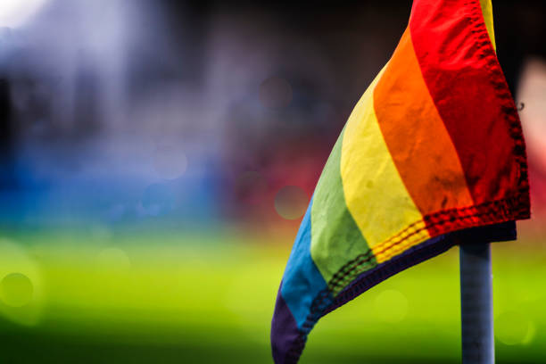 A Pride themed corner flag at a soccer stadium