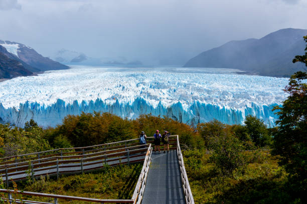 turisti che osservano il ghiacciaio sulle passerelle del ghiacciaio perito moreno del parco nazionale los glaciares in argentina. - glacier moreno glacier iceberg argentina foto e immagini stock