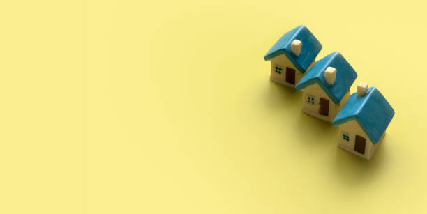 istock Miniature house over a yellow background with copy space. 1643413608