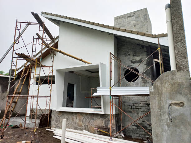 istock New house building is under construction, fixing the facade with finished plaster and paint. 1643429850