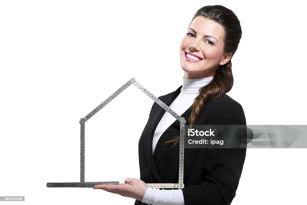 Young beautiful happy business woman house symbol Young beautiful happy business woman house symbol on white Adult Stock Photo