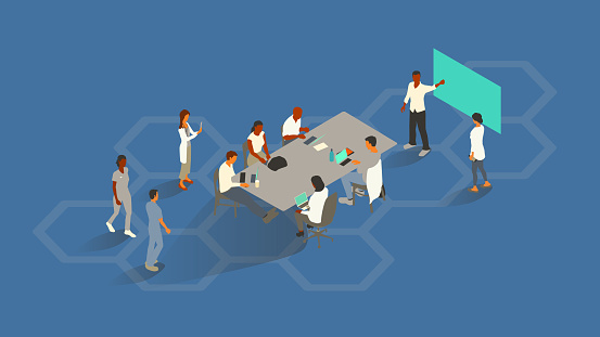 A group of 10 healthcare professionals gather around a conference table to illustrate the concept of collaboration. Diverse men and women use digital devices, while one gestures towards a presentation screen. Isometric vector presented in a 16x9 artboard, over a blue background and a hexagonal honeycomb pattern.