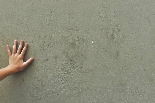 istock A girl's hand on a wall 1643510298