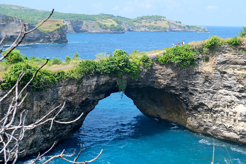 Natural arch at Broken Beach, an incredible little cove on the west coast of Nusa Penida island.