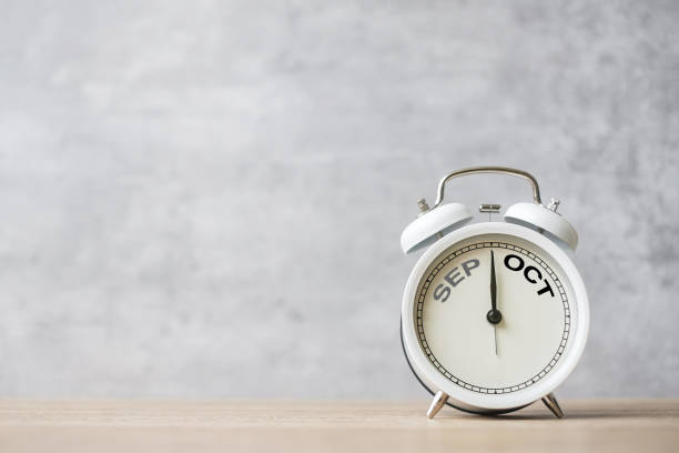 istock Hello October Changed from September  month with vintage alarm clock on table background. Calendar, Monthly, New Start, Resolution, Goals, Plan, Action and Mission Concept 1643536228