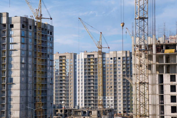 istock crane and a building under construction against a blue sky background 1643543663
