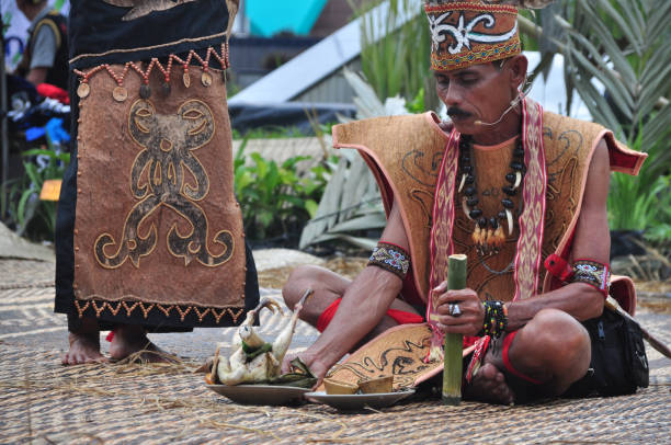 a comunidade dayak kanayatn está realizando uma tradicional cerimônia de ação de graças no tmii, jacarta - indonésia - dayak - fotografias e filmes do acervo