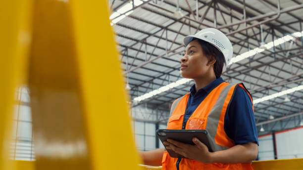 professional female industrial engineers tired take off helmet in manufacturing factory. working in manufacturing plant or production plant. - safety people equipment architect imagens e fotografias de stock