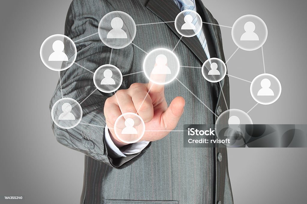 Businessman in gray suit using a social media display Social media concept. Businessman with hand pushing virtual social media button on grey background.High qaulity Digitally Generated Image Stock Photo