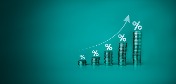 interest rates and dividends, economic growth, investment returns, income, pile of coins and upward direction percentage symbol. dividend from investment and bank saving concept. saving money, tax