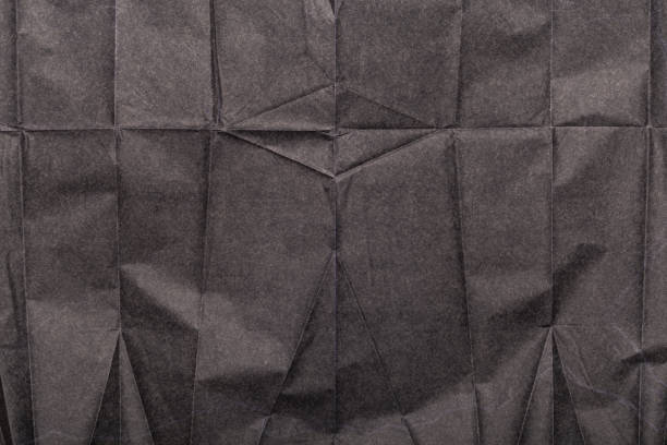 istock Crushed grunge carbon paper background texture, asset for graphic design 1643593929
