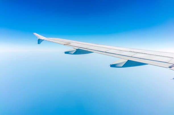 istock View from the airplane window at a beautiful cloudy sky and the airplane wing 1643598334