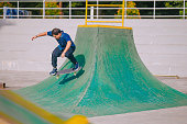 Romanian young man enjoy skateboarding stunt in skateboard park weekend morning