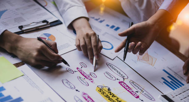 istock Group of  business hands with business financial documents. 1643688697