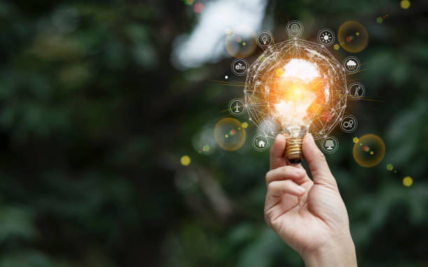 istock Hand holding light bulb  with against nature icons. 1643690870