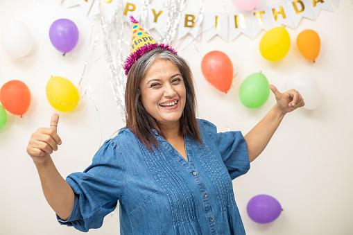 Happy indian asian old woman making party and enjoy life concept, Senior retired people celebrating birthday.