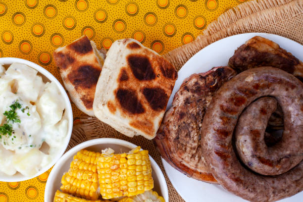braai day 24th September South African Braai Day or Heritage Day. Celebrating traditional braai food.
Meat and sides with traditional Shwe - Shwe cloth. south african braai stock pictures, royalty-free photos & images