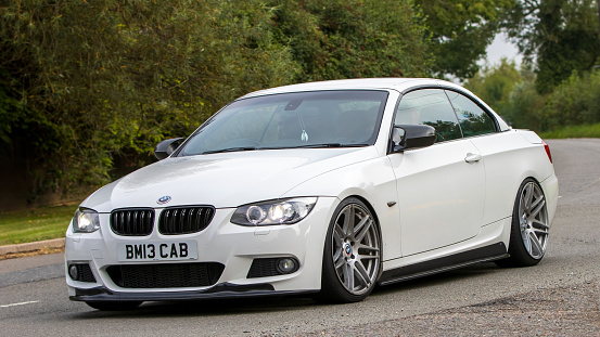 Whittlebury,Northants,UK -Aug 26th 2023: 2013 white BMW 3 series 320 d m sport car travelling on an English country road