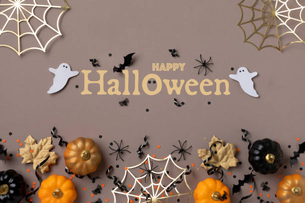istock Halloween background with party decorations from pumpkins, bats, spider web and ghosts top view. Holiday greeting card with text Happy halloween. 1643737210