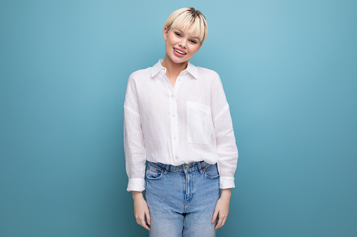 young pretty blond office worker woman in a white shirt and jeans. people lifestyle concept.