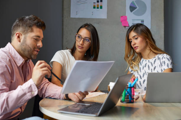 istock Colleagues discussing during meeting in office 1643777395