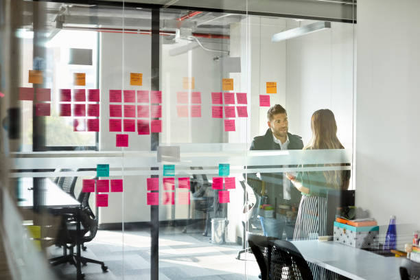 istock Colleagues discussing in board room at office 1643777974