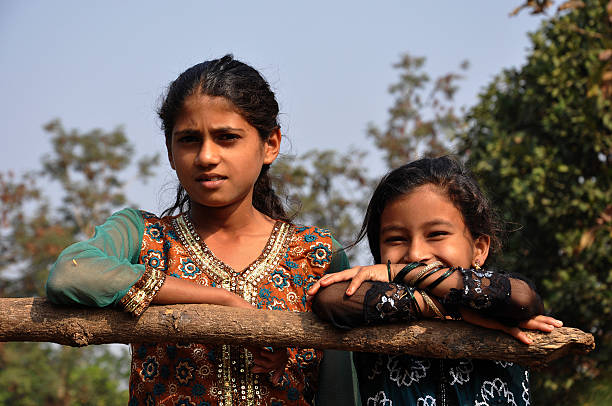 two indian girls poseing for camera happily... showcaseing happy indian rural life..
