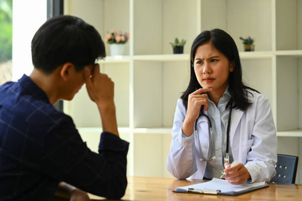 unhappy male patient having consultation with psychologist at at mental health clinic. psychotherapy and mental health concept - male nurse medical student healthcare and medicine nursing assistant imagens e fotografias de stock