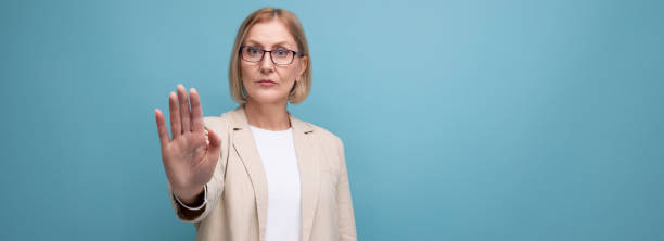 istock middle-aged woman business serious on bright studio background with copy space 1643810809