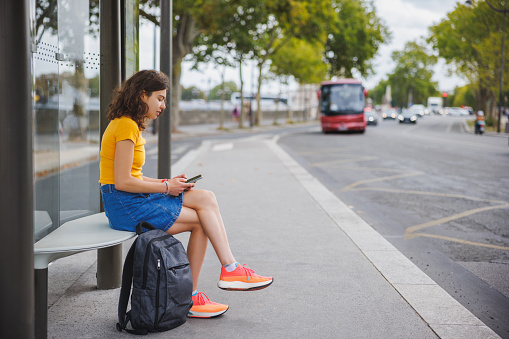 Student Stop Beautiful University Student Using Phone While Sitting At The Bus Stop ...