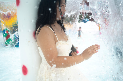 beautiful woman playing in water park