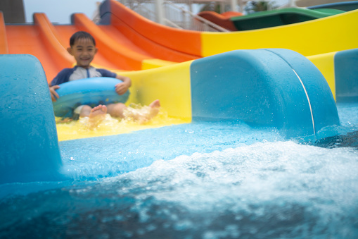 Two children playing on water slide